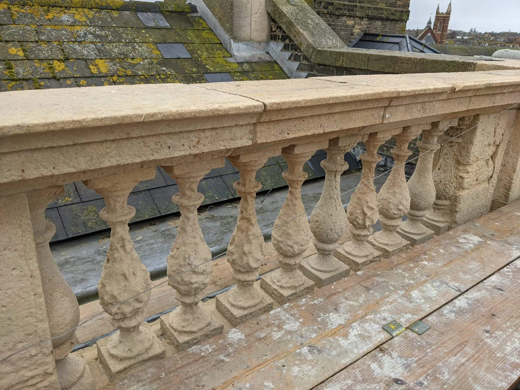 Figure 4 – Before and After: The stone balusters at the parapet were heavily weathered and showed significant signs of deterioration. As many of the original balusters were retained as possible, but many have been replaced replicating the profile of the original design, as can be seen in the second image.