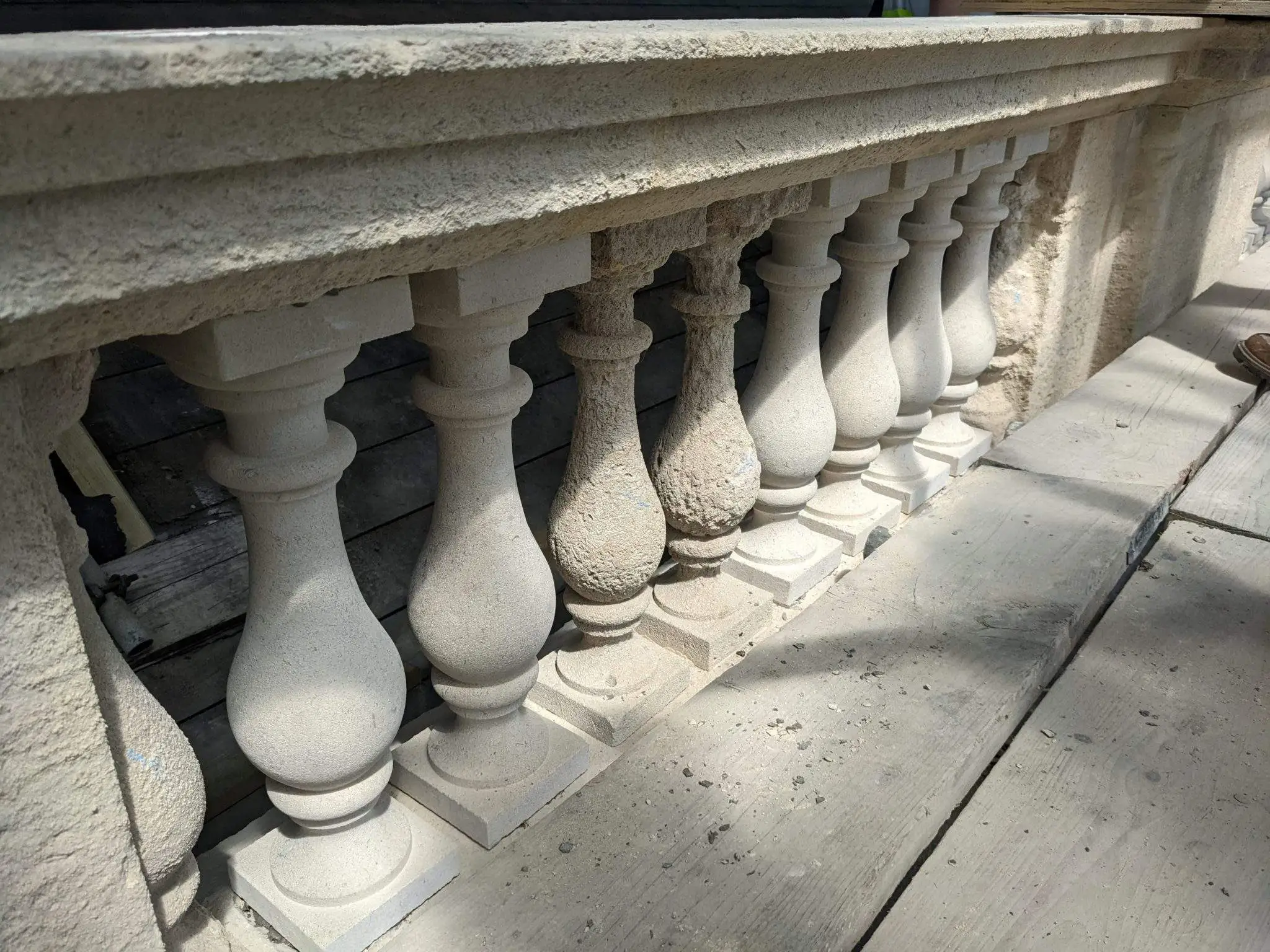 Figure 4 – Before and After: The stone balusters at the parapet were heavily weathered and showed significant signs of deterioration. As many of the original balusters were retained as possible, but many have been replaced replicating the profile of the original design, as can be seen in the second image.