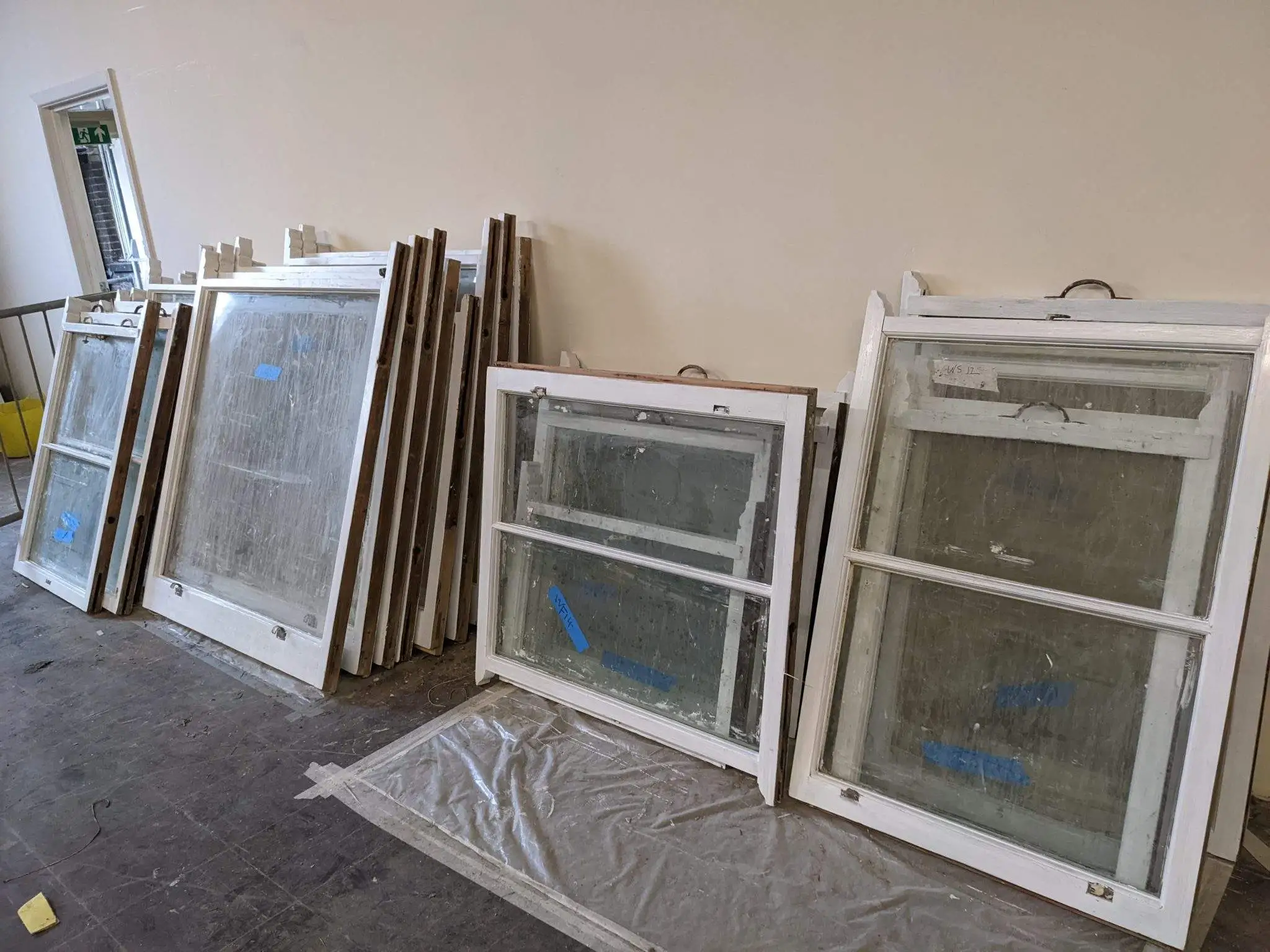 Figure 7 – Image showing the windows which have been repaired, primed with the linseed oil paint and ready for reinstallation