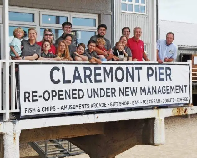 People gathered around a re opened sign